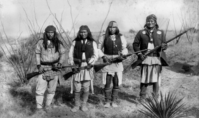 From right to left, Apache leader Geronimo, Yanozha (Geronimo's brother-in-law), Chappo (Geronimo's son by his second wife), and Fun (Yanozha's half brother) in 1886. Taken by C. S. Fly.
