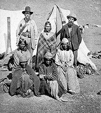 L to R, standing, US Indian agent, Winema (Toby) and her husband Frank Riddle, other Modoc women in front (1873)