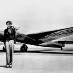 Amelia Earhart standing in front of the Lockheed Electra in which she disappeared in July 1937