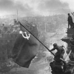 Raising a Flag over the Reichstag-photographed by Yevgeny Khaldei