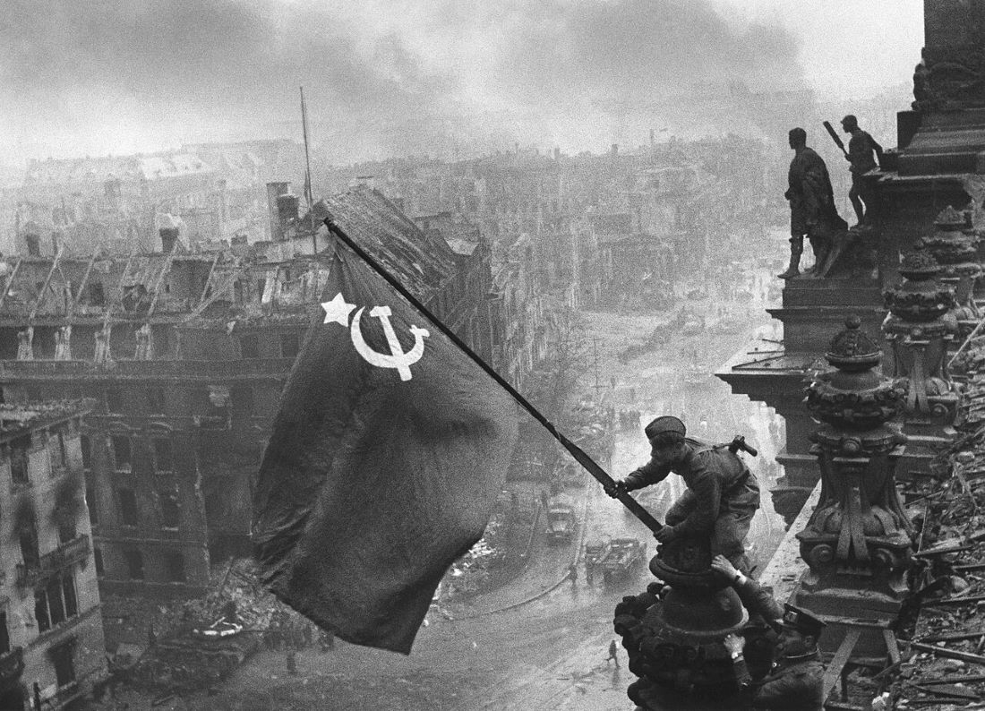 Raising a Flag over the Reichstag-photographed by Yevgeny Khaldei